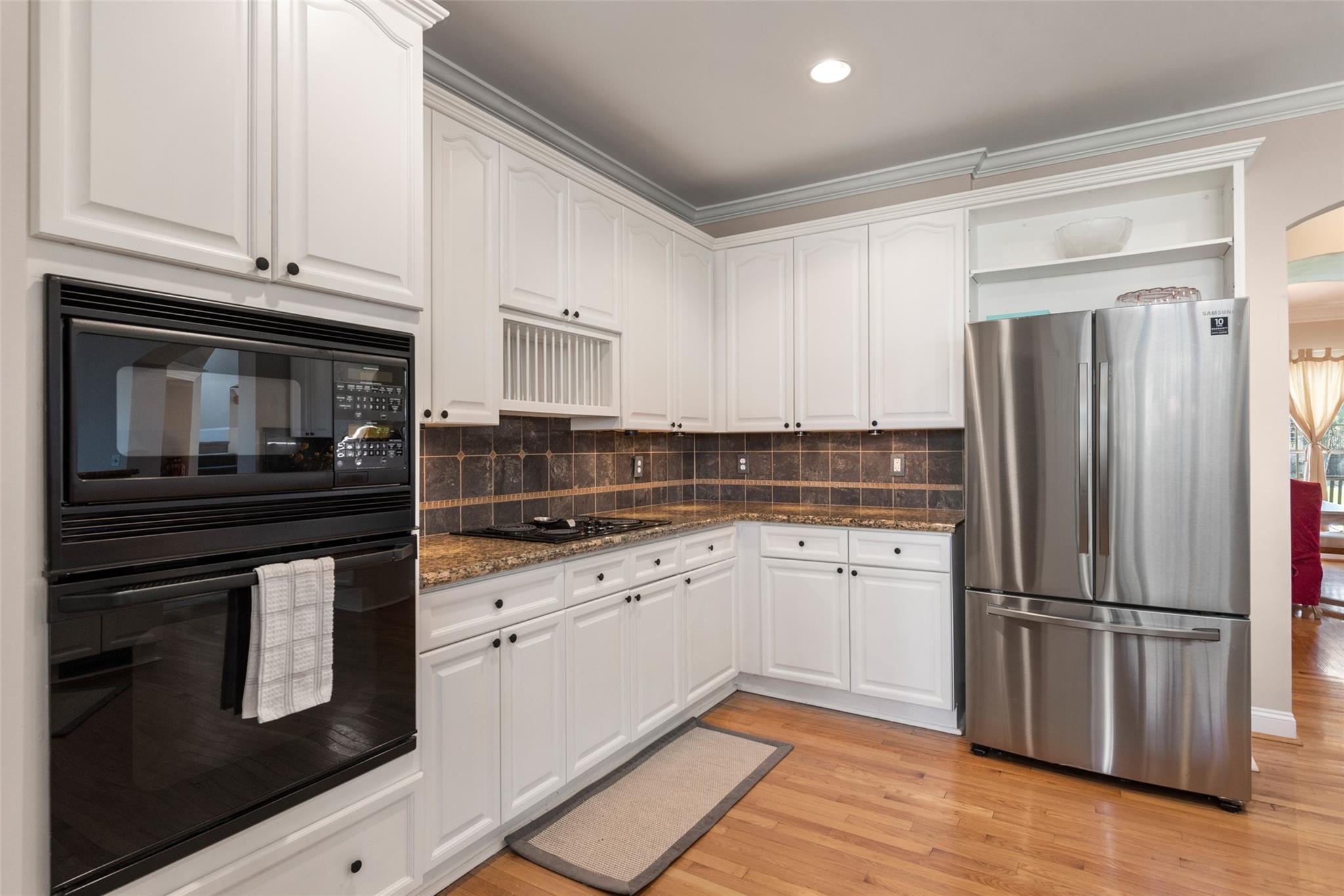 3519 Rhett Butler Place Charlotte, NC 28270 - Photo 16 of 38 a kitchen with granite countertop white cabinets and stainless steel appliances