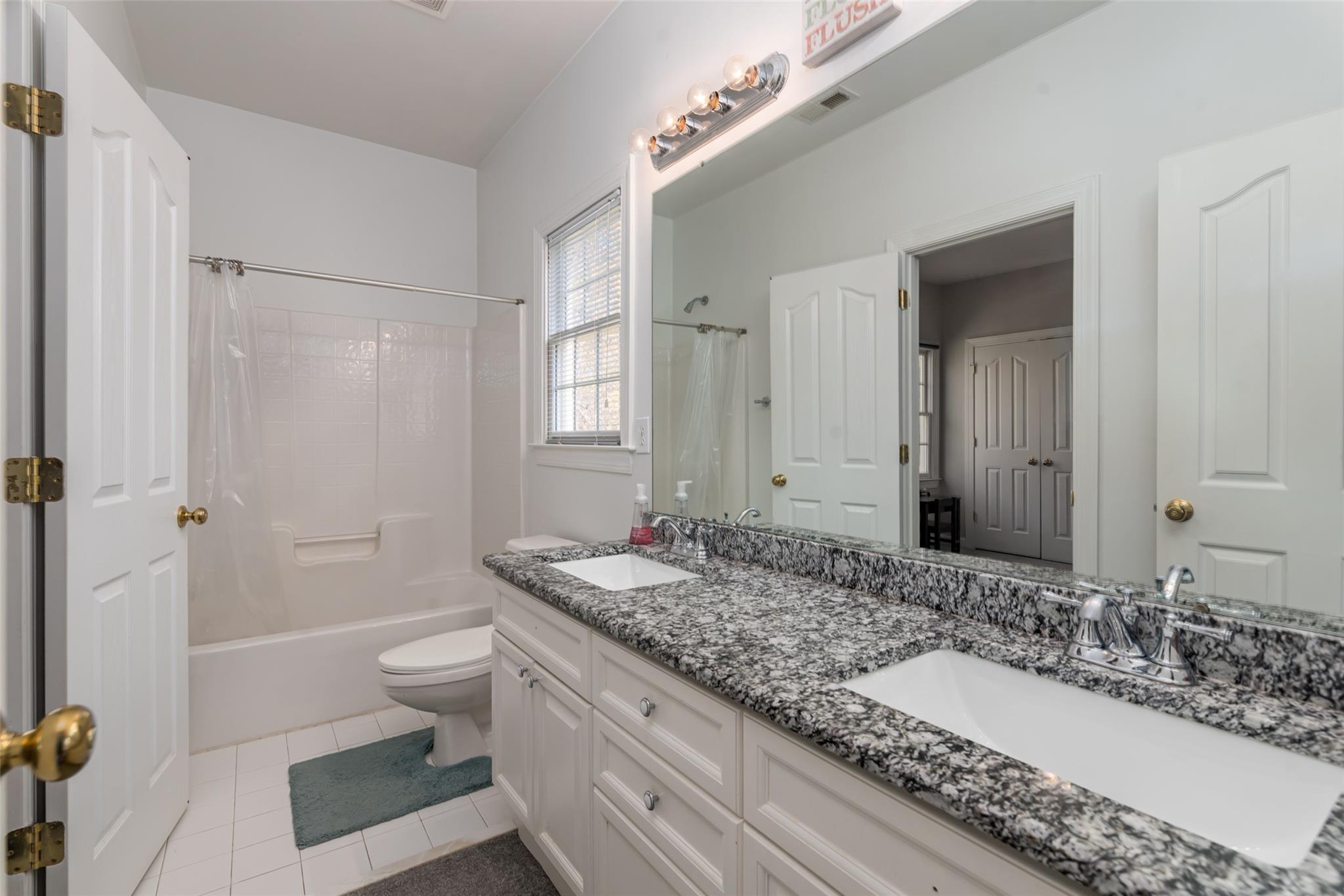 3519 Rhett Butler Place Charlotte, NC 28270 - Photo 30 of 38 a bathroom with a granite countertop double vanity sink a mirror and a bathtub