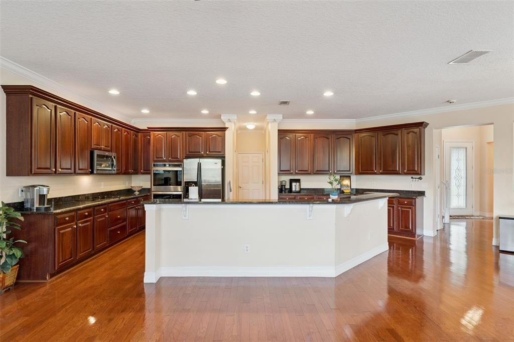 14790 Tullamore Loop Winter Garden, FL 34787 - Photo 12 of 42 a large kitchen with stainless steel appliances granite countertop a large counter top a stove a sink and a refrigerator