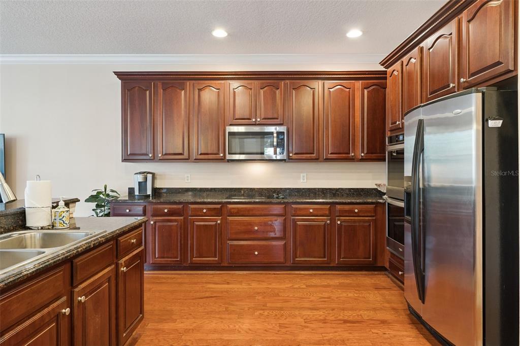14790 Tullamore Loop Winter Garden, FL 34787 - Photo 14 of 42 a kitchen with stainless steel appliances granite countertop a refrigerator a stove a sink and dishwasher