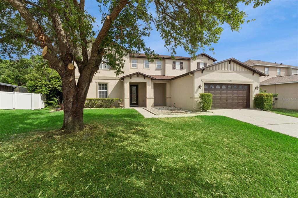 14790 Tullamore Loop Winter Garden, FL 34787 - Photo 2 of 42 a front view of a house with a garden and yard