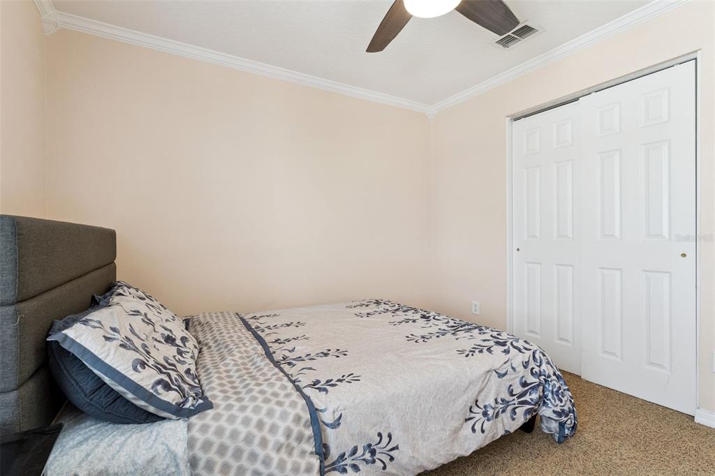14790 Tullamore Loop Winter Garden, FL 34787 - Photo 27 of 42 a bedroom with a bed and a chandelier fan