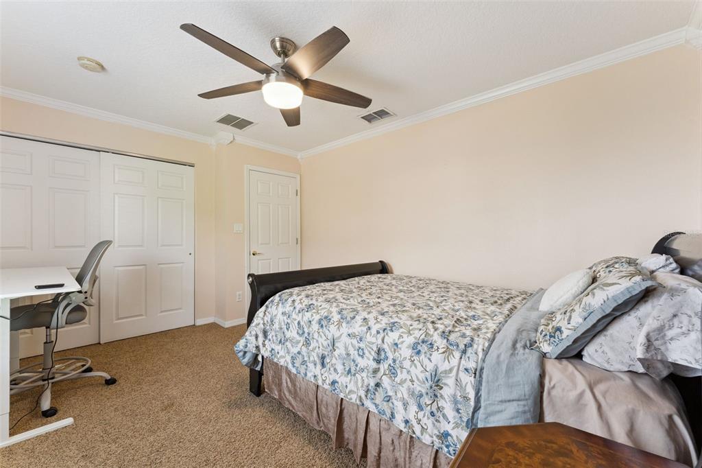 14790 Tullamore Loop Winter Garden, FL 34787 - Photo 29 of 42 a bedroom with a bed a desk and chair