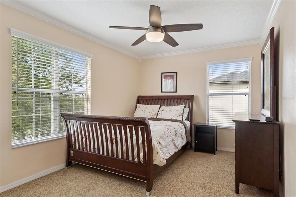 14790 Tullamore Loop Winter Garden, FL 34787 - Photo 30 of 42 a bed sitting in a bedroom next to a window
