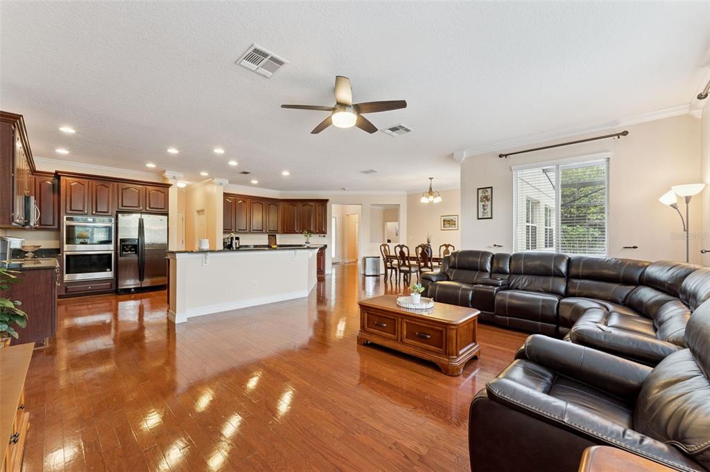 14790 Tullamore Loop Winter Garden, FL 34787 - Photo 9 of 42 a living room with furniture kitchen view and a wooden floor