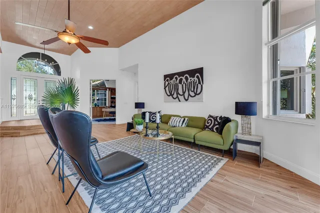a kitchen with stainless steel appliances granite countertop a sink and a large window