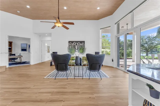 a room with pool table and windows