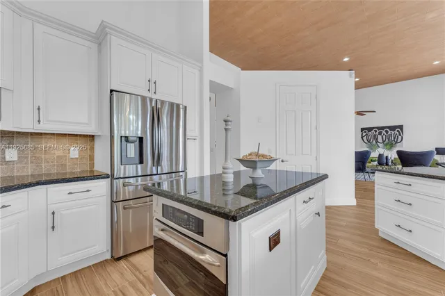 an empty room with a bench and a window