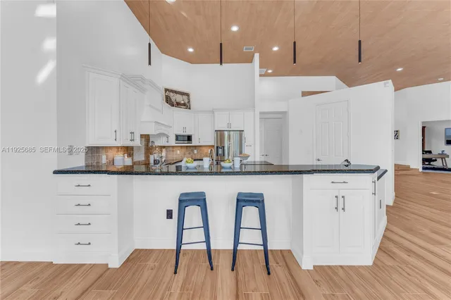 a building outdoor space with patio furniture and potted plants