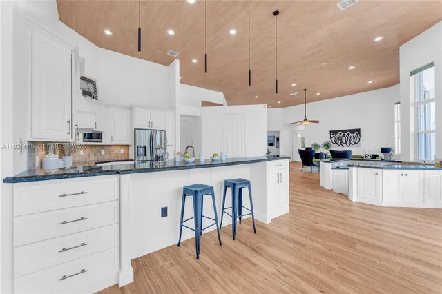 a living room with patio furniture and a garden