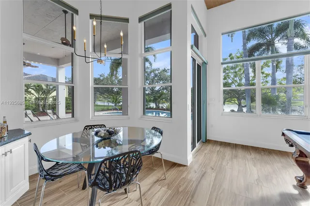 a view of a swimming pool with a yard and plants