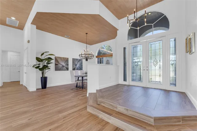 a kitchen with stainless steel appliances granite countertop a stove and a large window
