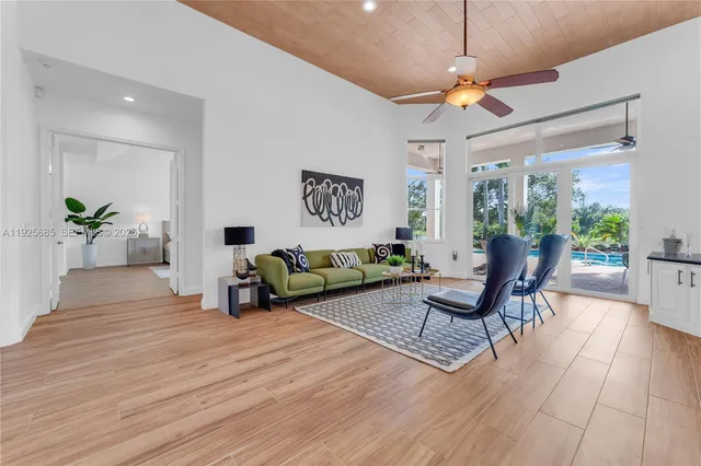 a kitchen with stainless steel appliances granite countertop a sink a stove and a wooden floors