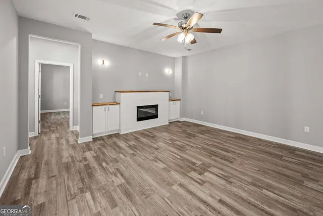 wooden floor in an empty room with a fireplace