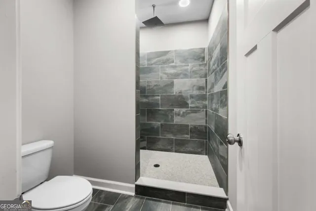 a bathroom with a shower and a toilet