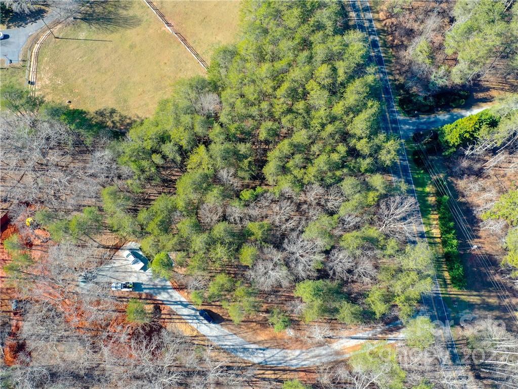 5 Riva Ridge Lane Columbus, NC 28722 - Photo 10 of 12 a backyard of a house with a yard and large tree