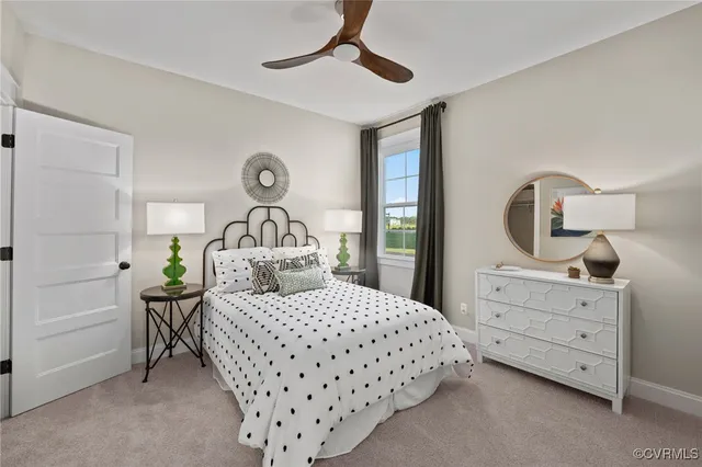 a bedroom with a bed a chandelier with dresser and mirror