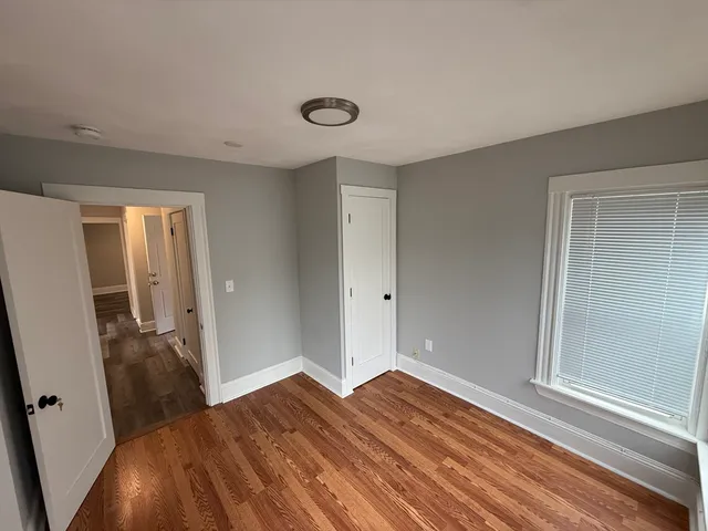 a view of a room with wooden floor and bathroom