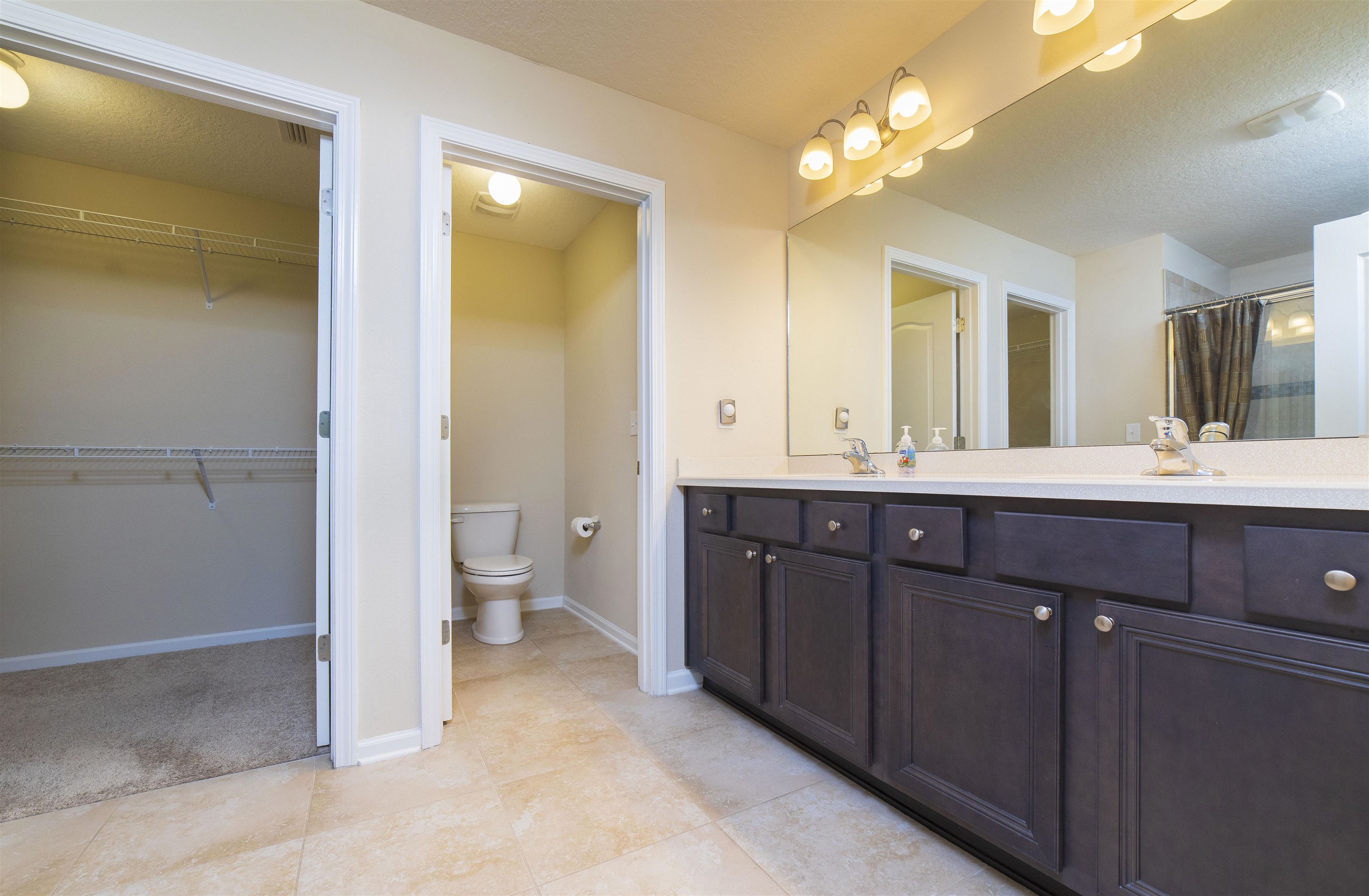 341 Deer Crossing Road St. Augustine, FL 32086 - Photo 23 of 46 a bathroom with a double vanity sink and a mirror