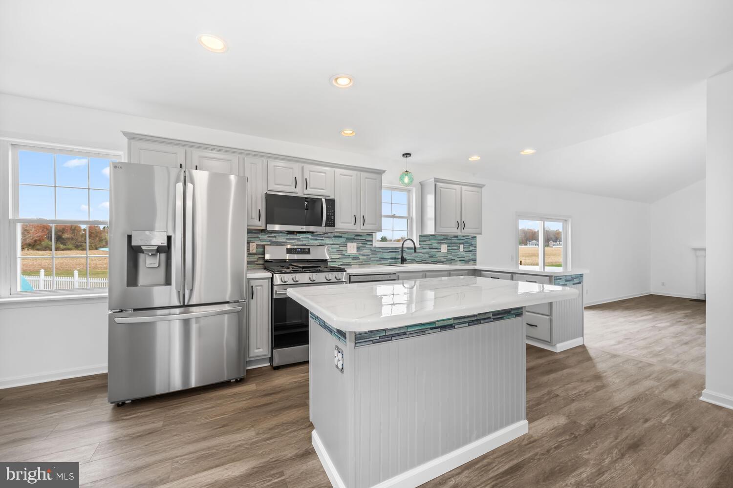119 Wye Knot Road Queenstown, MD 21658 - Photo 19 of 45 a kitchen with stainless steel appliances granite countertop a kitchen island hardwood floor sink and stove