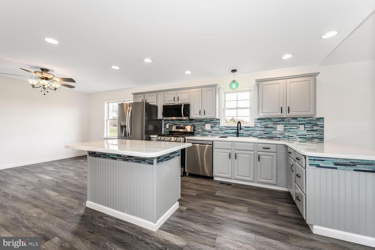 119 Wye Knot Road Queenstown, MD 21658 - Photo 20 of 45 a kitchen with granite countertop stainless steel appliances and wooden cabinets