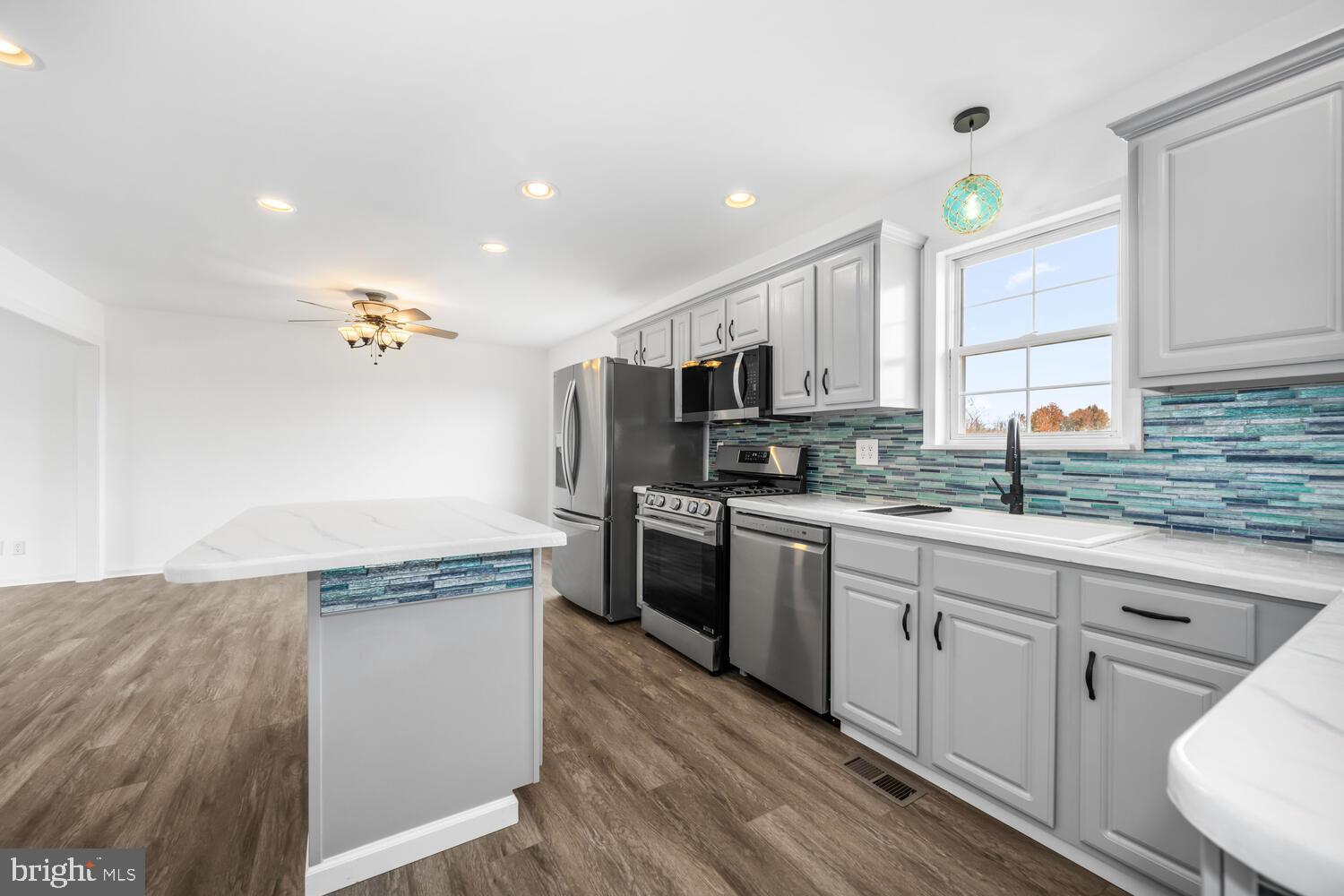 119 Wye Knot Road Queenstown, MD 21658 - Photo 21 of 45 a kitchen with kitchen island granite countertop a sink cabinets and stainless steel appliances