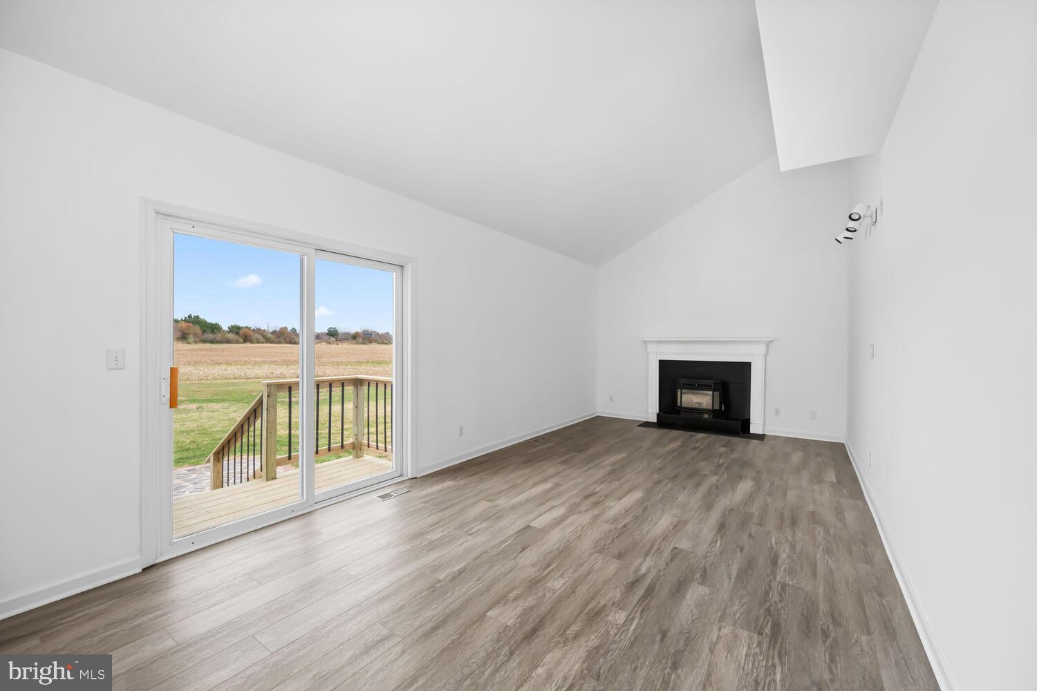 119 Wye Knot Road Queenstown, MD 21658 - Photo 23 of 45 an empty room with kitchen view and wooden floor