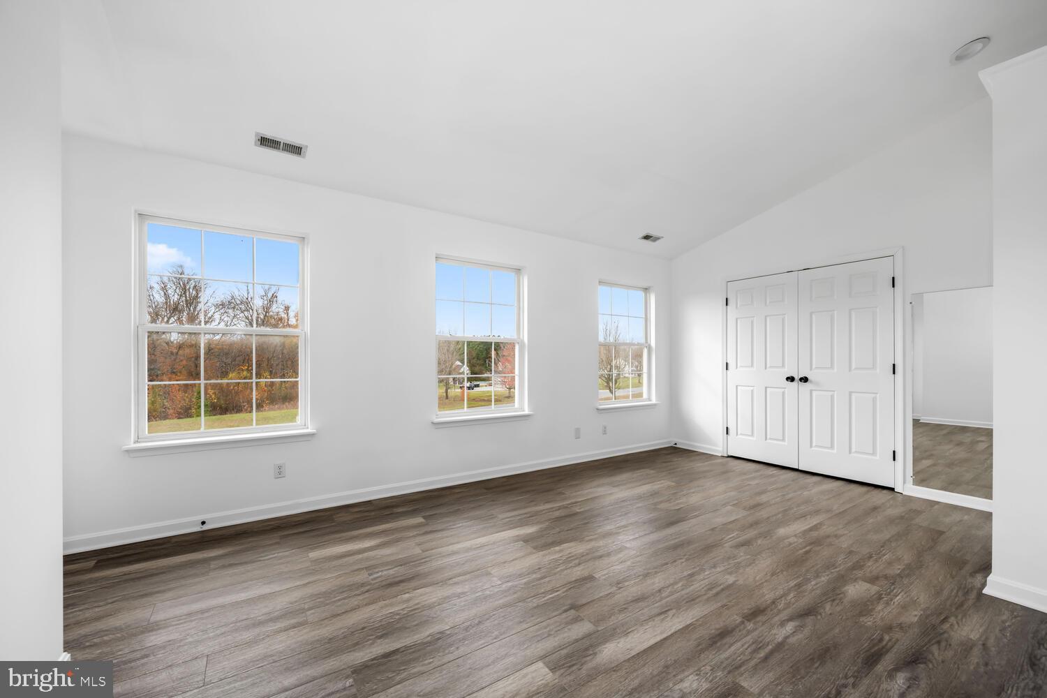 119 Wye Knot Road Queenstown, MD 21658 - Photo 27 of 45 an empty room with wooden floor and windows
