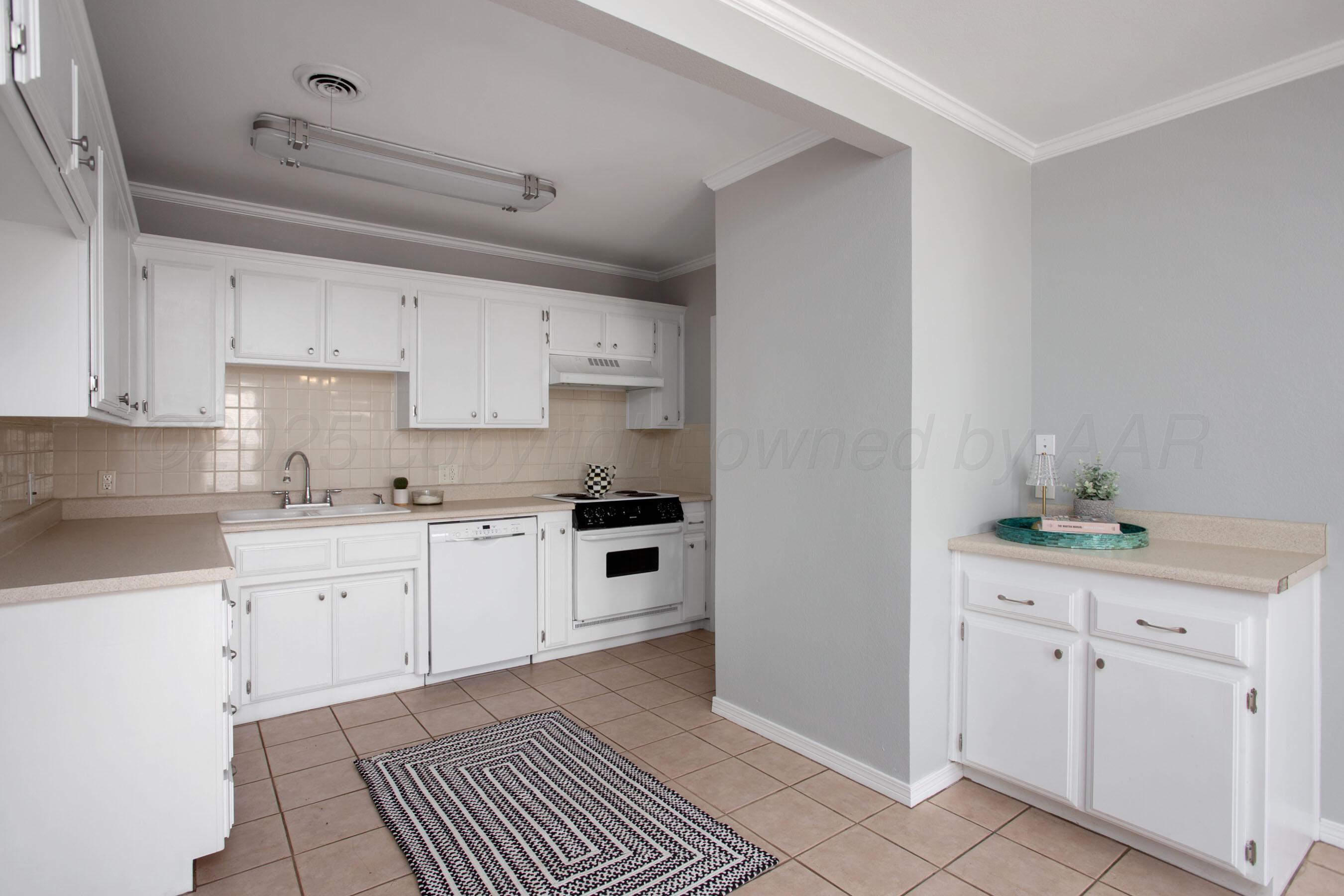 406 Sunset Terrace Amarillo, TX 79106 - Photo 14 of 25 a kitchen with granite countertop white cabinets and white appliances
