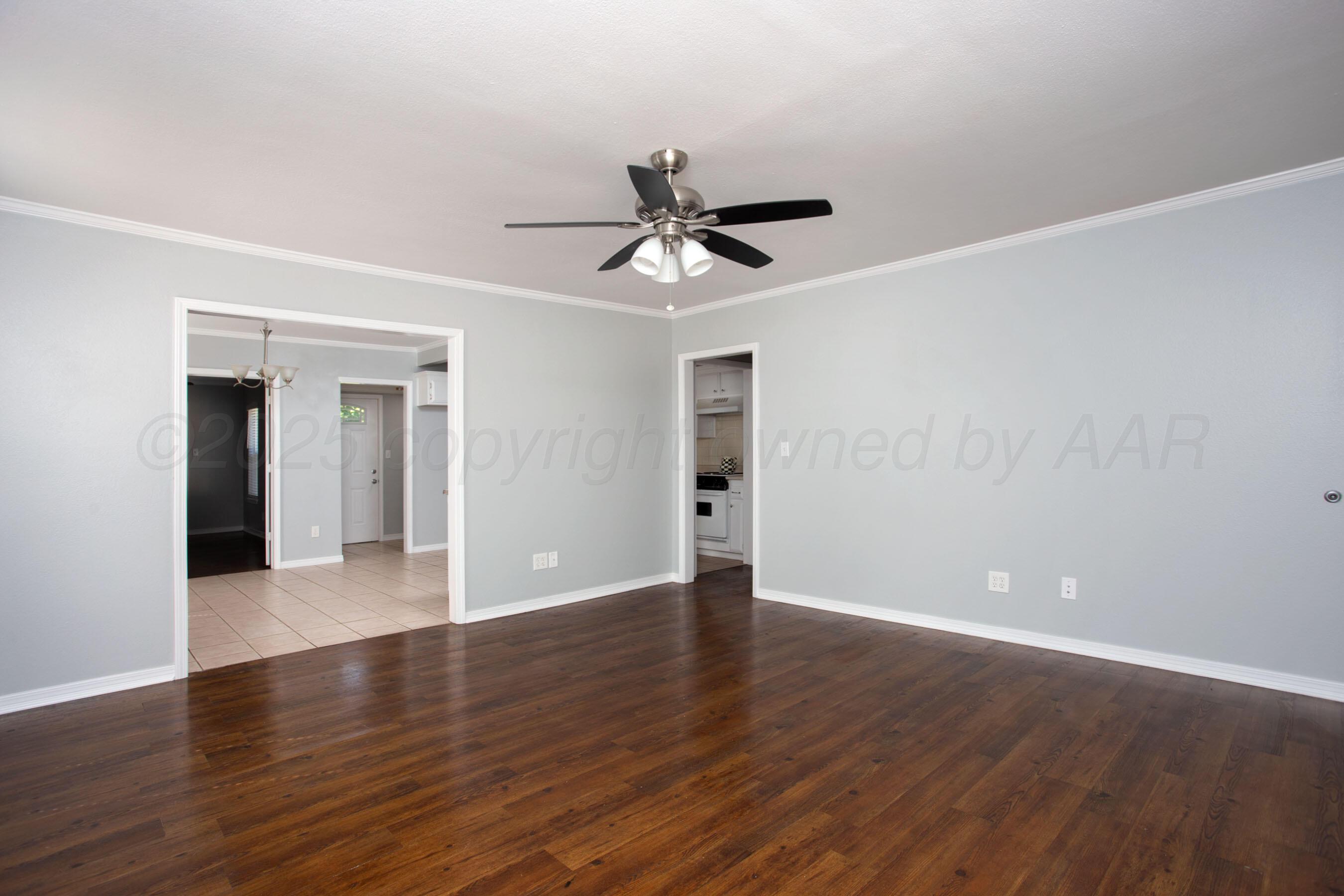 406 Sunset Terrace Amarillo, TX 79106 - Photo 21 of 25 a view of a room with wooden floor and a ceiling fan
