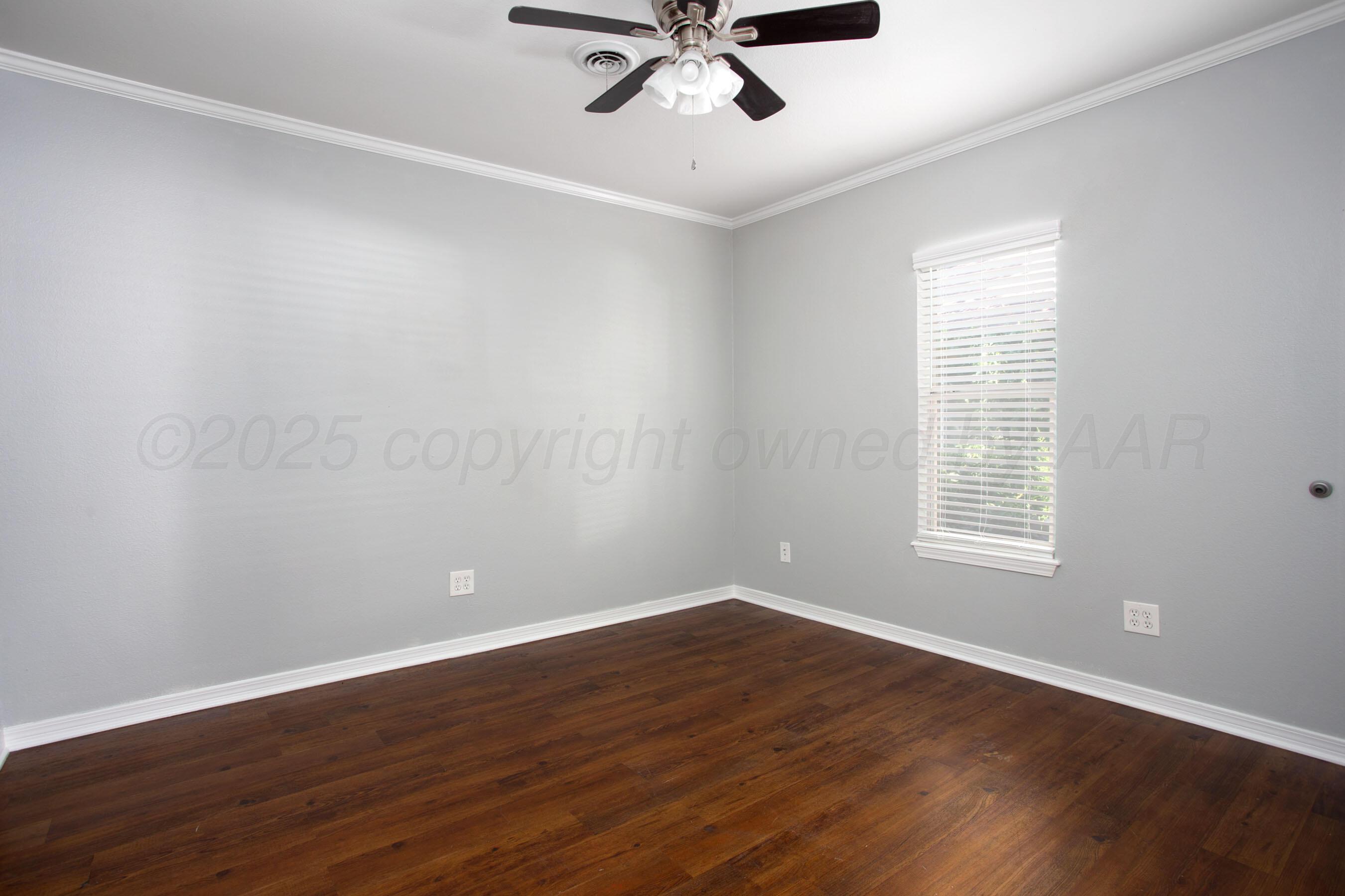 406 Sunset Terrace Amarillo, TX 79106 - Photo 7 of 25 a view of a room with wooden floor and windows