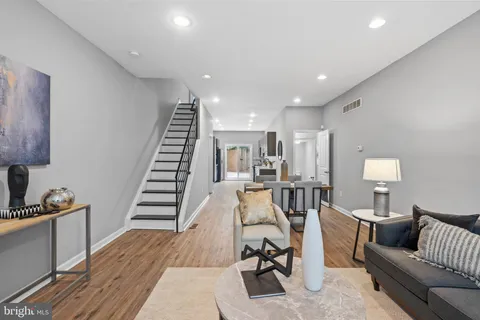 a view of a living room and a couch with wooden floor