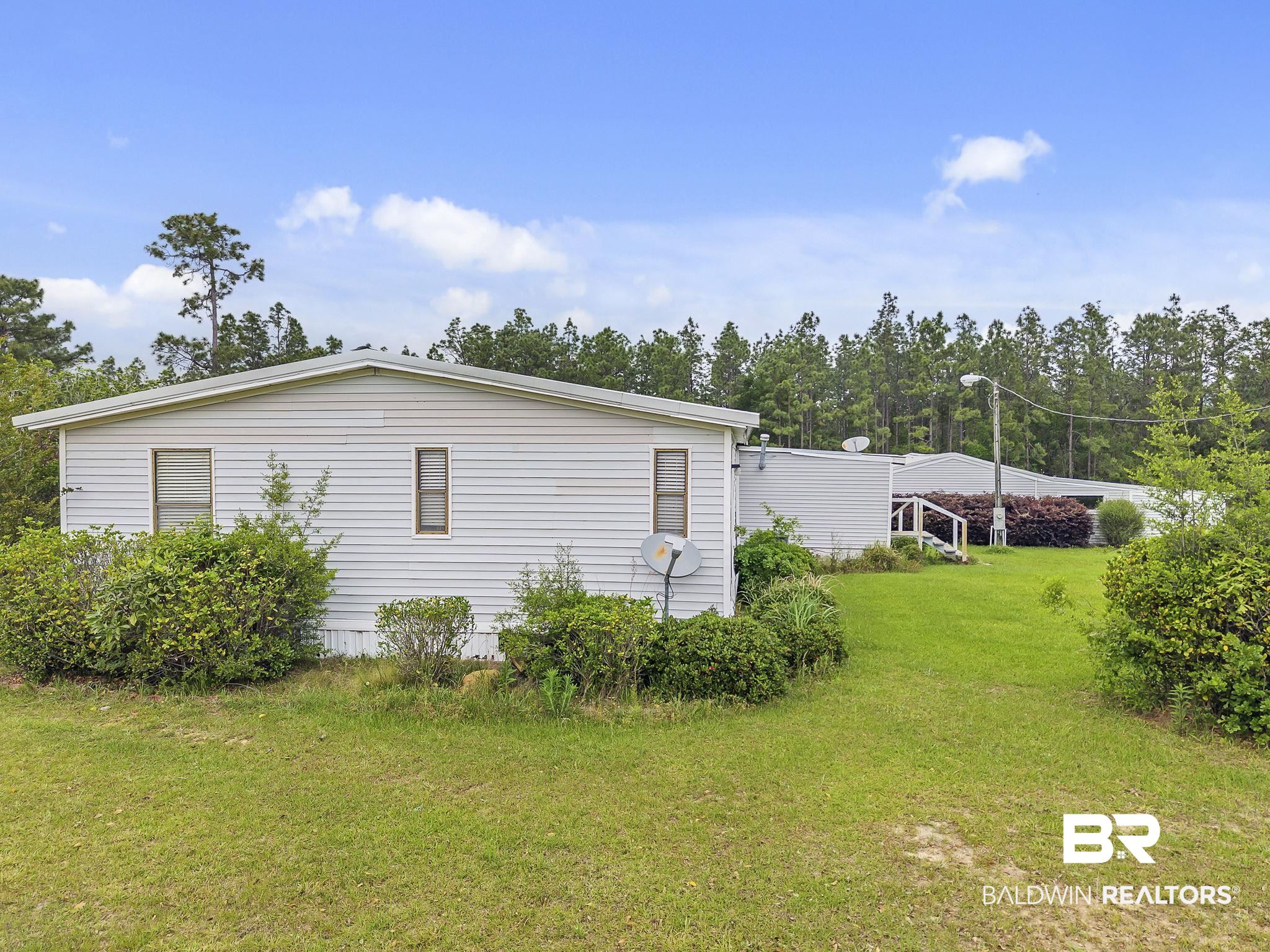 29792 County Road 65 Loxley, AL 36551 - Photo 17 of 39 View of home's exterior featuring a yard
