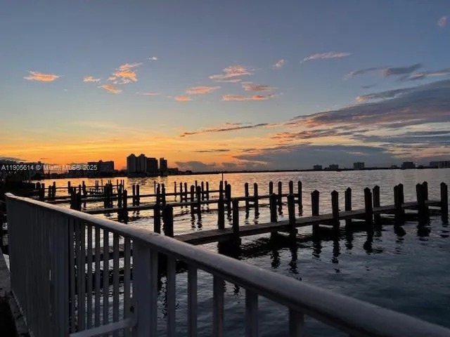 a view of a patio with a table and chairs under an umbrella