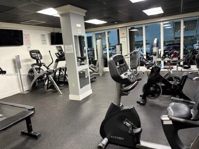 a bathroom with a granite countertop tub sink and mirror