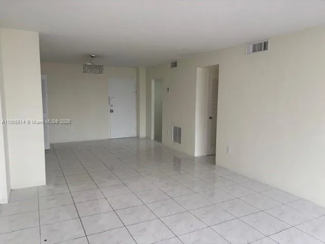 a view of an empty room with entryway