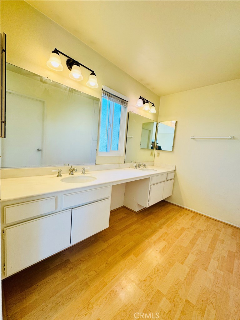 10 Coldbrook Irvine, CA 92604 - Photo 17 of 21 a bathroom with a double vanity sink and a mirror