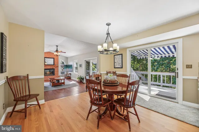 a view of a dining room with furniture and a floor to ceiling window