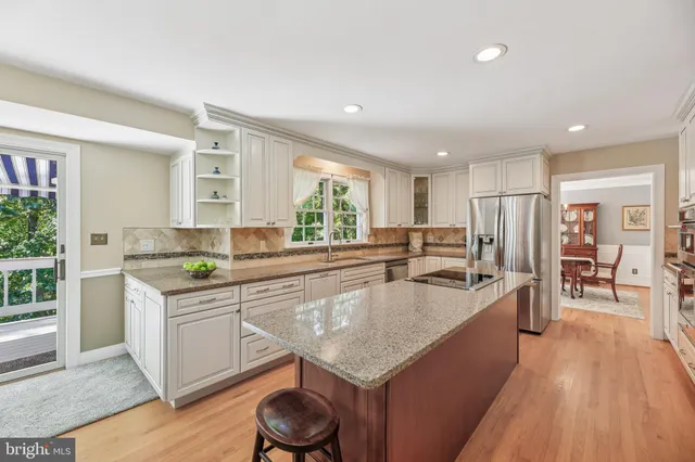 a kitchen with stainless steel appliances a refrigerator sink and cabinets