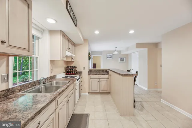 a spacious bedroom with a bed and a chandelier