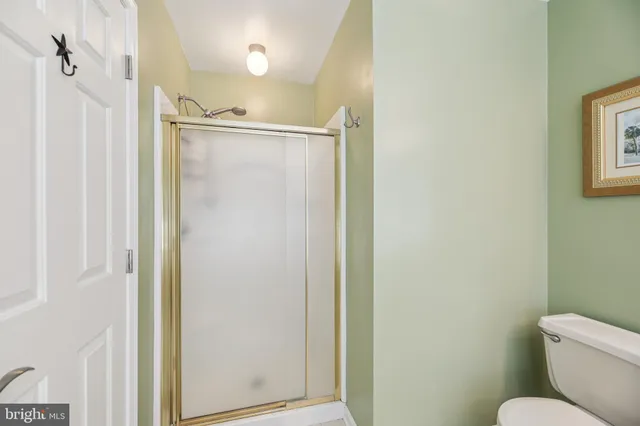 an aerial view of a house with outdoor space and trees all around