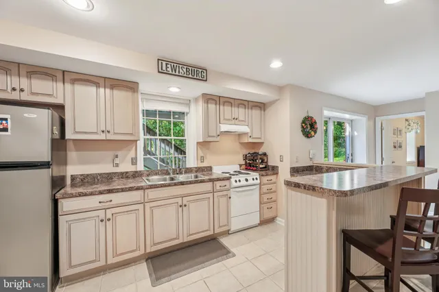 an aerial view of a house with swimming pool and garden