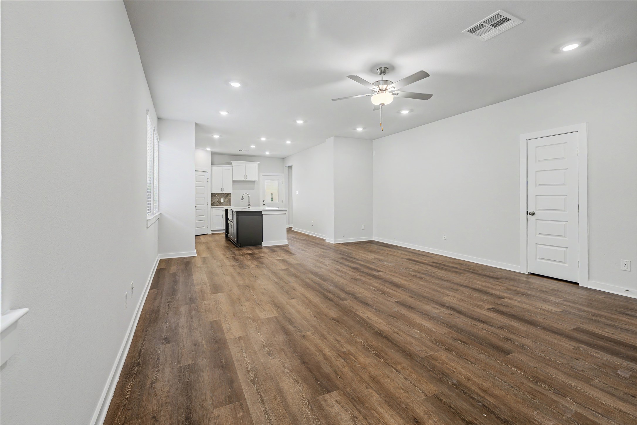 6423 Bolinas Court Rosharon, TX 77583 - Photo 5 of 39 a view of a kitchen with wooden floor and a ceiling fan