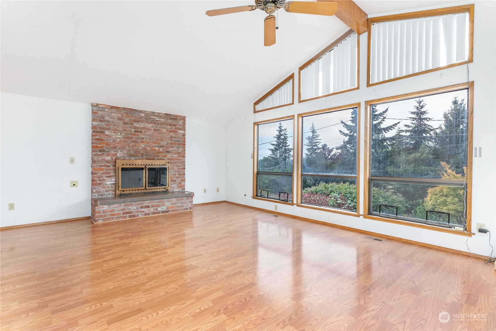 2650 Cherry Avenue Bremerton, WA 98310 - Photo 3 of 25 an empty room with wooden floor fireplace and windows