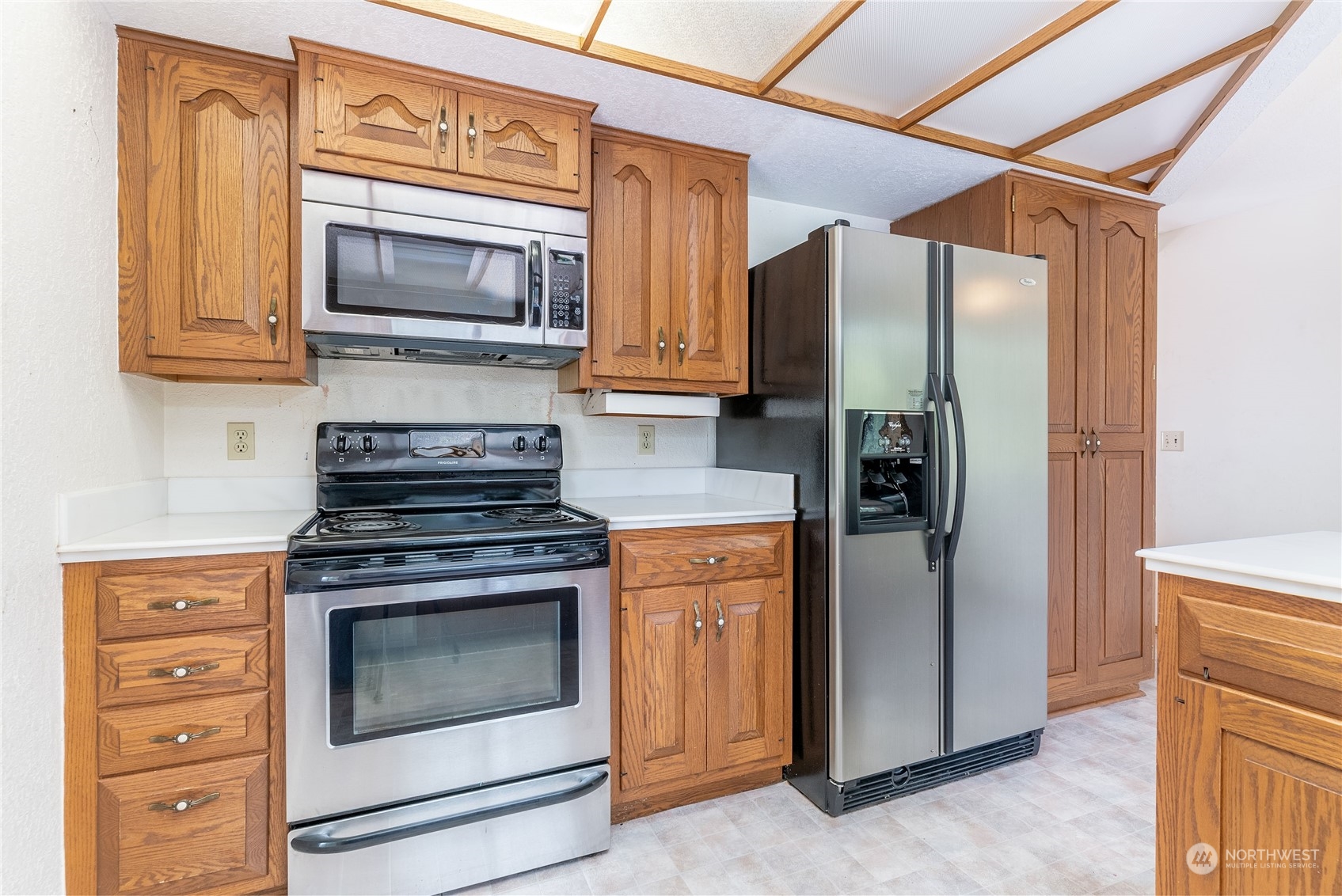 2650 Cherry Avenue Bremerton, WA 98310 - Photo 9 of 25 a kitchen with stainless steel appliances granite countertop a stove microwave and refrigerator