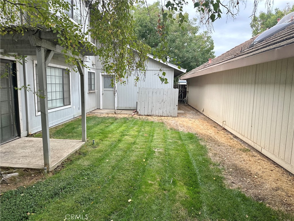 3072 Ironwood Court Merced, CA 95340 - Photo 23 of 25 a backyard of a house with lawn chairs and wooden fence