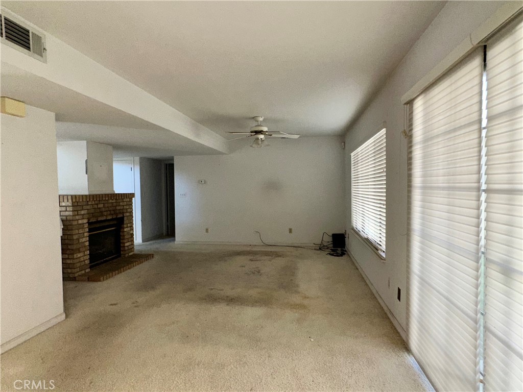 3072 Ironwood Court Merced, CA 95340 - Photo 6 of 25 a view of an empty room with a fireplace and a window