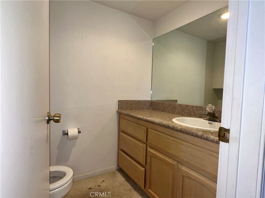 3072 Ironwood Court Merced, CA 95340 - Photo 8 of 25 a bathroom with a granite countertop sink a toilet and a shower