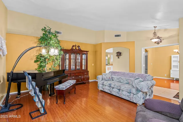 a bedroom with furniture and a wooden floor