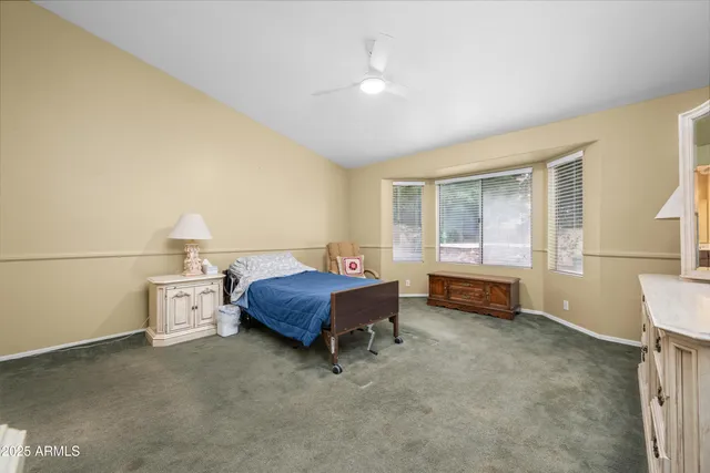 a bedroom with a bed and a large window